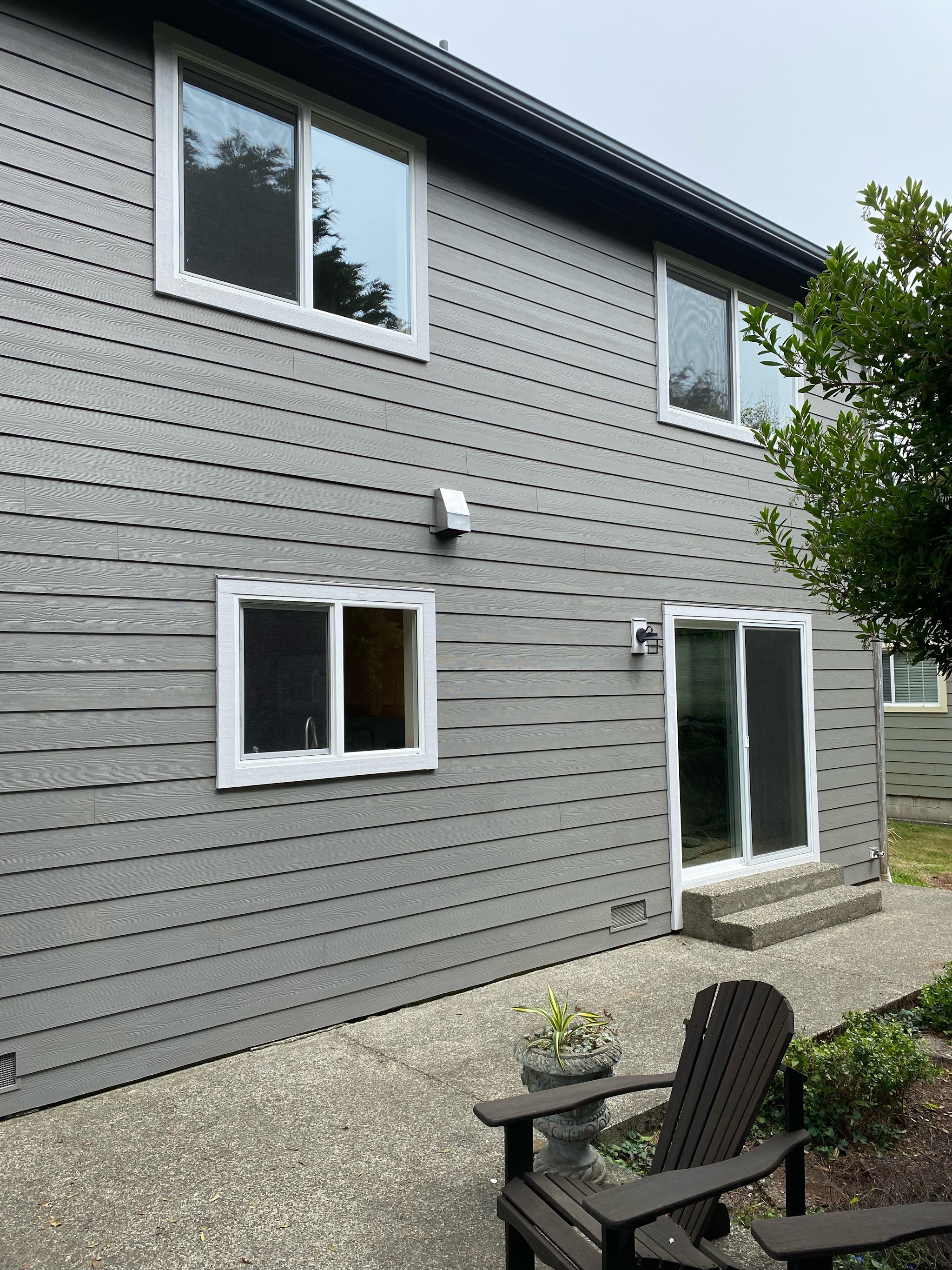 Finished exterior siding on a two-story home, general contracting scope